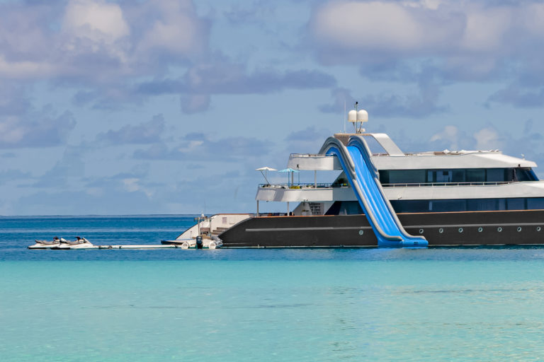 yachting boat with water slide, maldives islands.